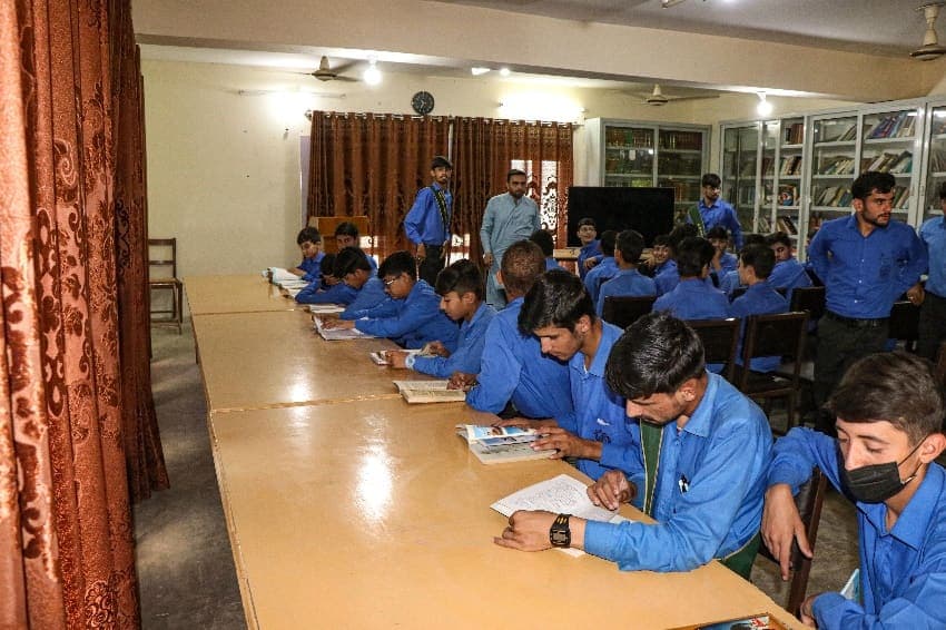 Students reading at long tables in the library